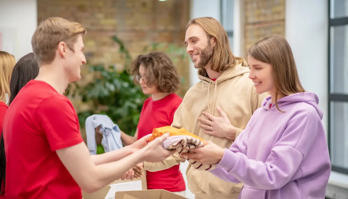 Des bénévoles reçoivent des vêtements lors d’une action solidaire soutenue par le mécénat d’entreprise.